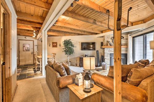 a living room with brown couches and a table at Ski and Hike Mtn-View Condo in Silverthorne! in Silverthorne