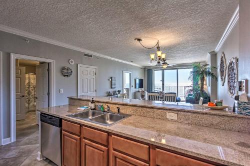 a kitchen with a sink and a view of the ocean at Beachfront Condo with Stunning Ocean Views and Pool! in Panama City Beach