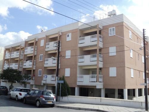 a building with cars parked in front of it at Lykavitos Apartments in Nicosia