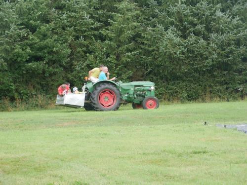 a group of people riding on a tractor at Le Venec, Lopérec, France in Lopérec