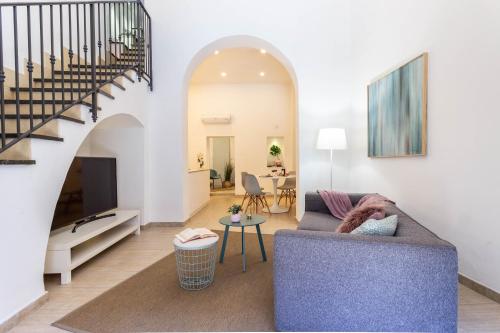 a living room with a couch and a table at Dama Sicilian Luxury Home & SPA in Giarre