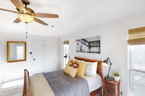 a bedroom with a bed with a ceiling fan at Guadalupe Oasis in Seguin