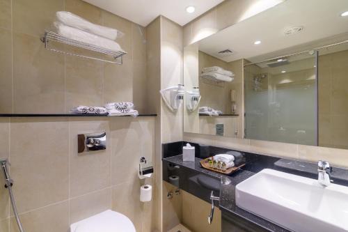a bathroom with a sink and a mirror at Dhafra Beach Hotel in Jebel Dhanna