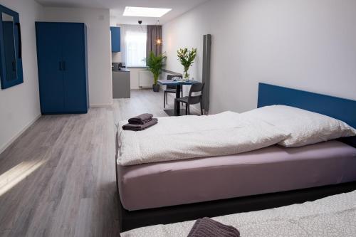 a bedroom with a bed and a room with a table at Hotel A24 bei Hamburg in Glinde