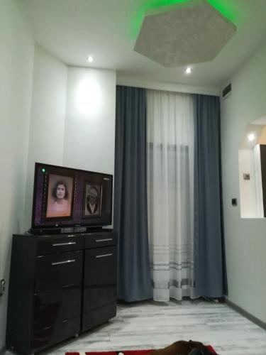 a living room with a tv on a dresser at Data Central Studio in Novi Sad