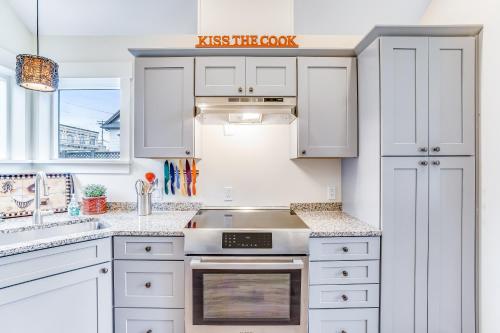 a kitchen with white cabinets and a sink at Mariner's Rest -C in Anacortes