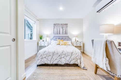 a white bedroom with a bed and a window at Mariner's Rest -C in Anacortes