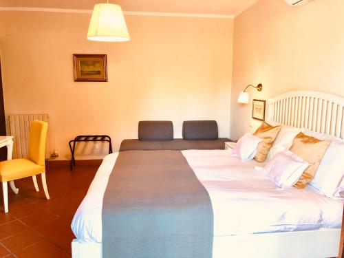 a hotel room with a large bed and a chair at Casa Ciampi Locazione Turistica in Pisa