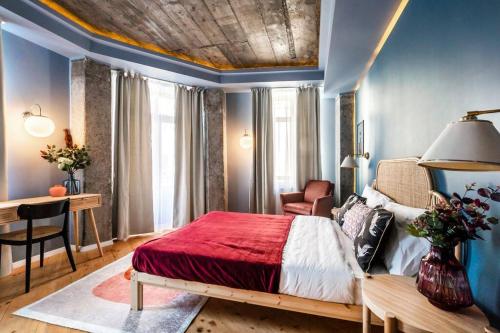 a bedroom with a bed and a desk in a room at Marvellous Design 2Br Old Town in Bucharest