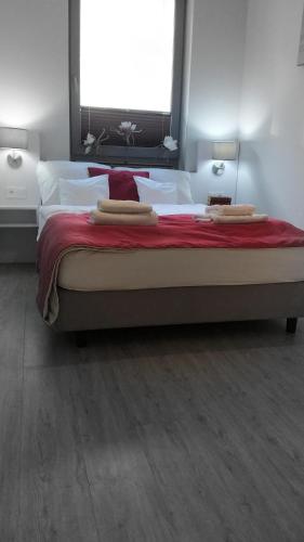 a large bed in a bedroom with a large window at Apartament Elvira, Grunwaldzka 12C in Pobierowo