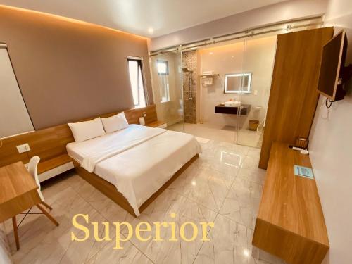 a hotel room with a bed and a bathroom at La Galerie Hotel in Ho Chi Minh City