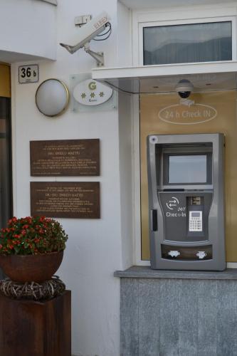 an atm machine on the side of a building at Hotel Goldene Rose in Brunico