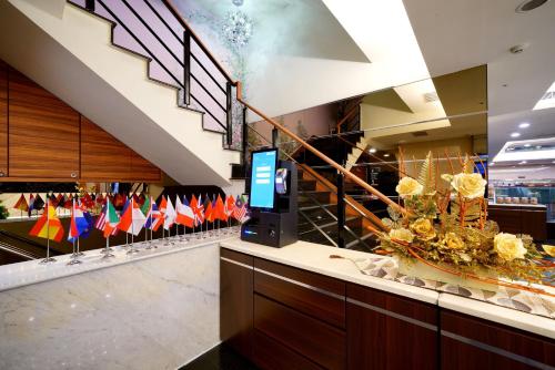 a lobby with a bunch of flags on a counter at Sa-Yo Hotel - Pier 2 in Kaohsiung