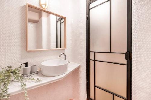 a bathroom with a sink and a mirror at Marvellous Design Studio Old Town in Bucharest