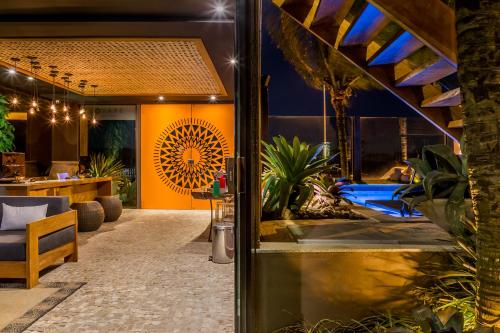 a lobby of a hotel with a pool and plants at Bravo Pousada Design in Cabo Frio