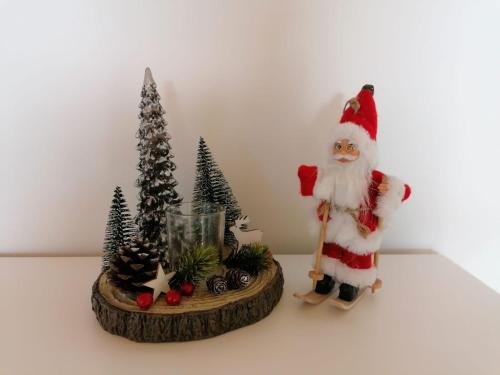 a santa clause and christmas trees on a table at BergAufe Chalets Mallnitz in Mallnitz