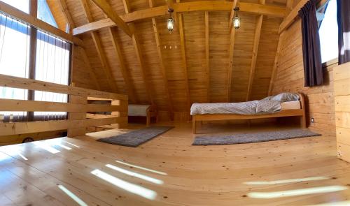 a wooden room with a bed in the middle of it at Vikendica Pavle in Trebinje