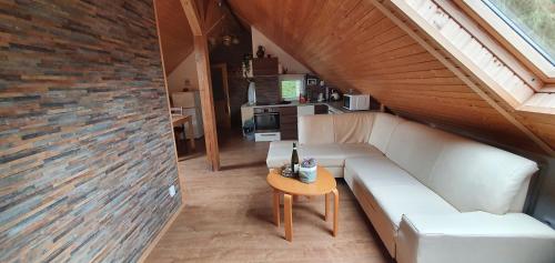 a living room with a white couch and a table at Lipno & Wellness Chata in Loučovice