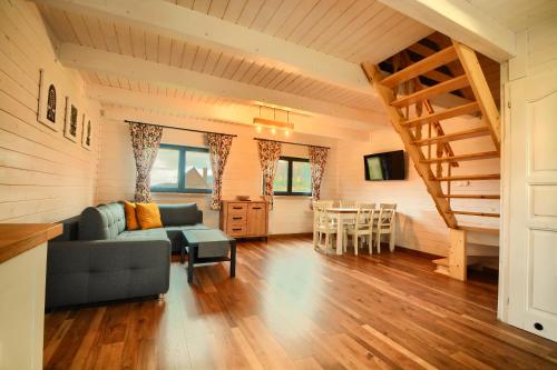 a living room with a couch and a table at Siedlisko Leśnica - domki całoroczne Brenna in Brenna