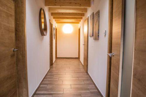 a hallway with a tile floor and wooden doors at BergAufe Chalets Mallnitz in Mallnitz