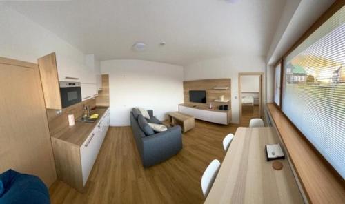 a living room with a couch and a table at Hotel U Kabinky in Janske Lazne