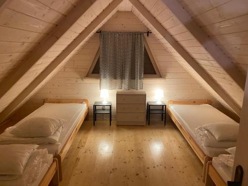 a room with two beds in a attic at Nad Zalewem - Kluczbork- domki całoroczne in Ligota Zamecka
