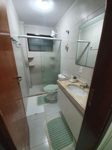 a bathroom with a sink and a toilet and a mirror at Winterville Resort Flat 910 Gravatá-Pe in Gravatá