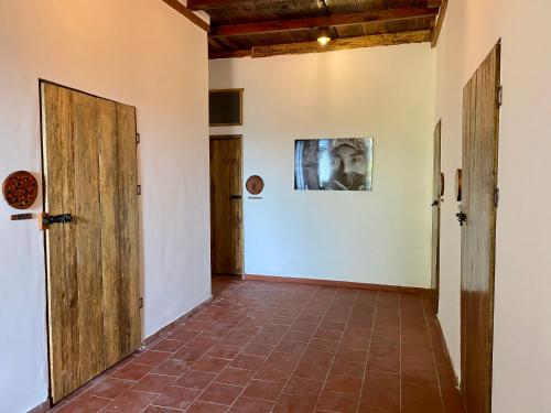 a room with a door open and a door leading to a hallway at Mundo Nuevo Eco Lodge in Minca