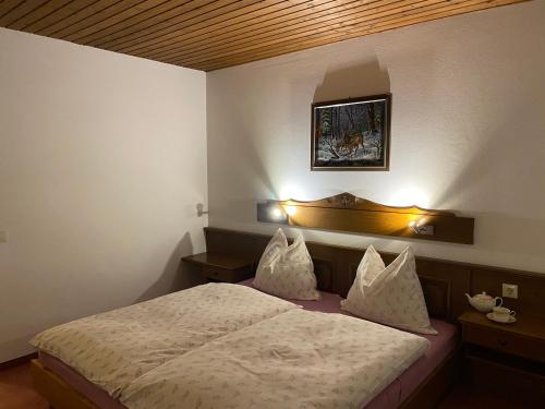 a bedroom with a bed with two pillows at Haus Kleinberg in Filzmoos