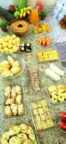 a table topped with lots of different types of food at Infinity Hotel in Goiânia