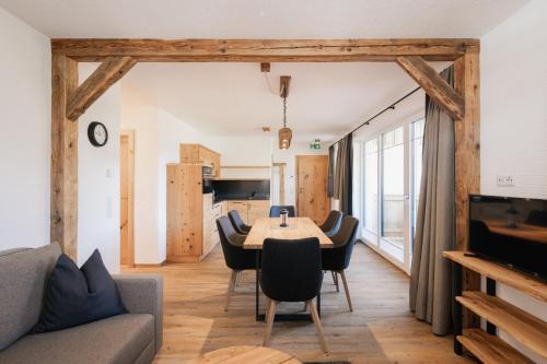 a living room with a table and chairs at Landhaus Holzer in Sankt Margarethen im Lungau