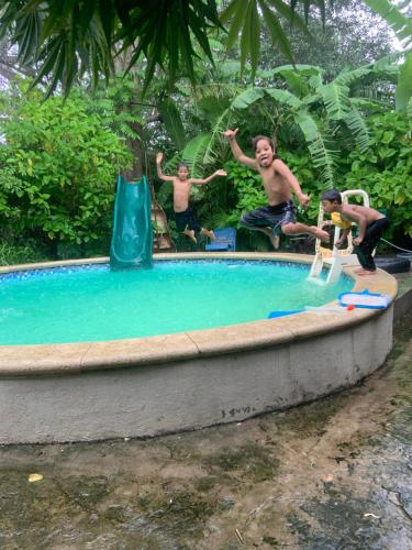 a group of men playing in a swimming pool at Quinta Mi Tata B&B in Sardinal