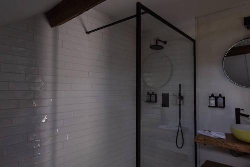 a shower with a glass door in a bathroom at vakantiewoning maison doute in Durbuy