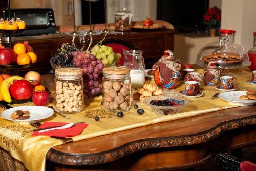 a table filled with fruits and vegetables and jars of food at Gran Suite Piazza Maggiore - T&T communications in Bologna