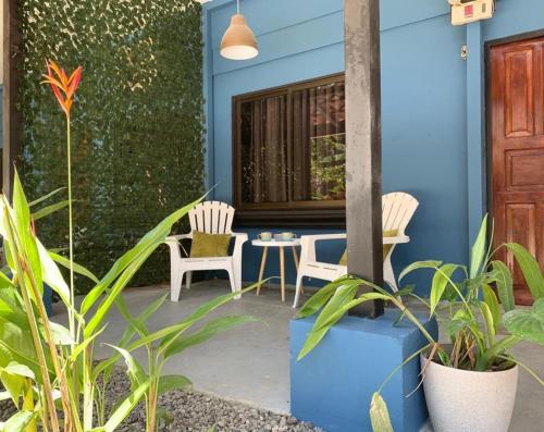a patio with two chairs and a table in a house at Point Break Santa Teresa in Santa Teresa Beach