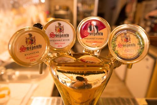 a glass of beer with five labels on it at Luxusní horský apartmán v Beskydech in Malenovice