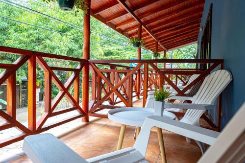 a wooden balcony with a table and chairs on it at Point Break Santa Teresa in Santa Teresa Beach