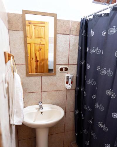a bathroom with a sink and a mirror at Point Break Santa Teresa in Santa Teresa Beach