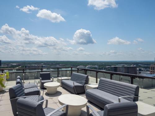 a balcony with chairs and tables on a building at Bluebird Suites at Reston Town Center in Reston
