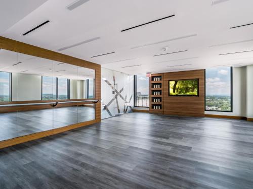 an empty living room with wood floors and windows at Bluebird Suites at Reston Town Center in Reston
