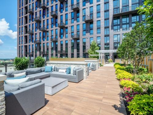 a patio with couches in front of a tall building at Bluebird Suites at Reston Town Center in Reston