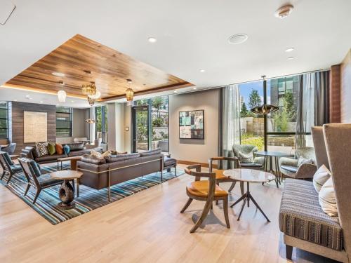 an open living room with furniture and windows at Bluebird Suites at Reston Town Center in Reston