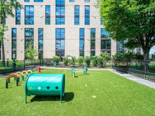 a playground in a park in front of a building at Bluebird Suites at Reston Town Center in Reston