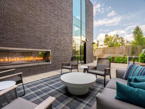 a patio with a fireplace and furniture at Bluebird Suites at Reston Town Center in Reston