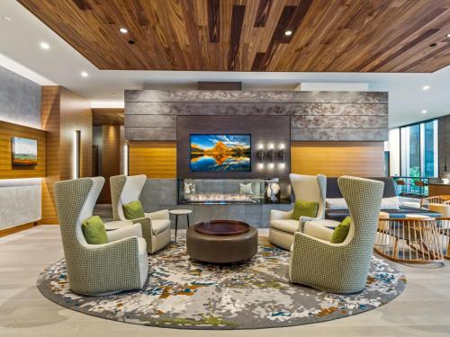 a lobby with chairs and a fireplace at Bluebird Suites at Reston Town Center in Reston