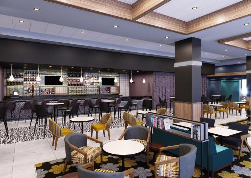 a restaurant with tables and chairs and a bar at Hyatt Place Tampa Downtown in Tampa
