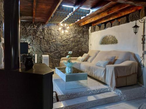 a living room with a couch and a table at ALOELUX VILLA ! - Private Villa with Jacuzzi, cinema ,massage ,wonderful view, art desing villa in Conil