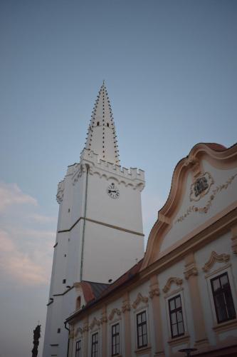 a building with a tower with a clock on it at Penzion U Johanky in Kadaň