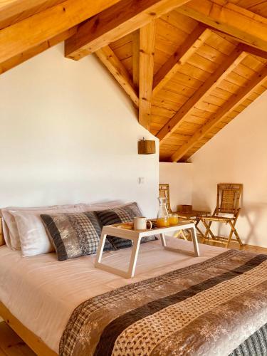 a bedroom with a bed and a table at Planinska Koliba Exclusive in Sekulić 