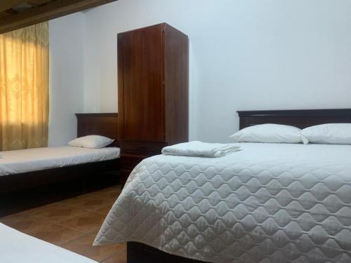 En eller flere senge i et værelse på Casa del Peregrino Santo Thomas